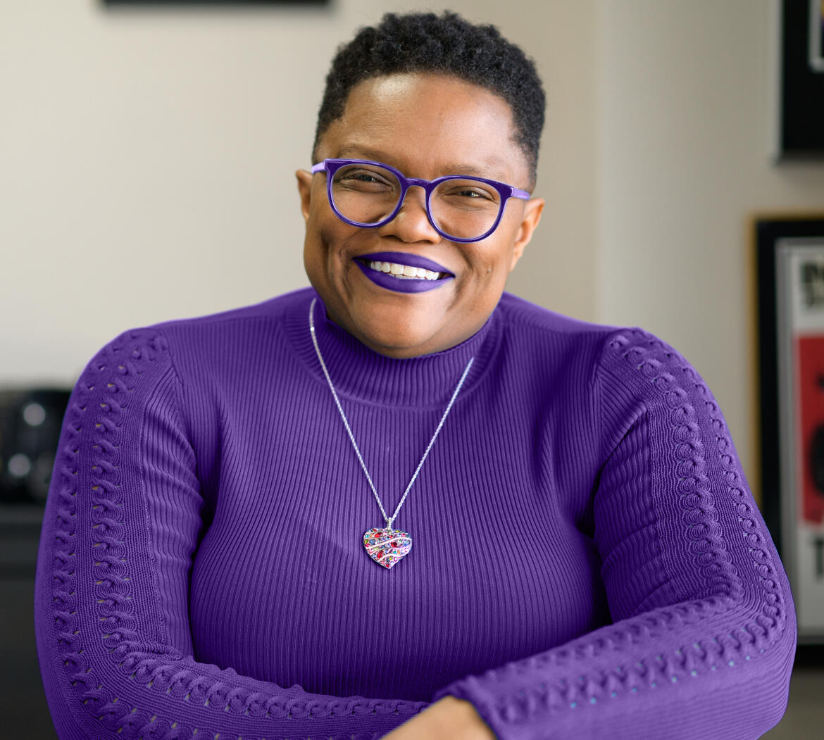 Tia A Williams in Purple Glasses, Lipstick and Sweater Tia A Williams, Principal Systems-Thinking Architect & Author. Creator of The Leadership Equation